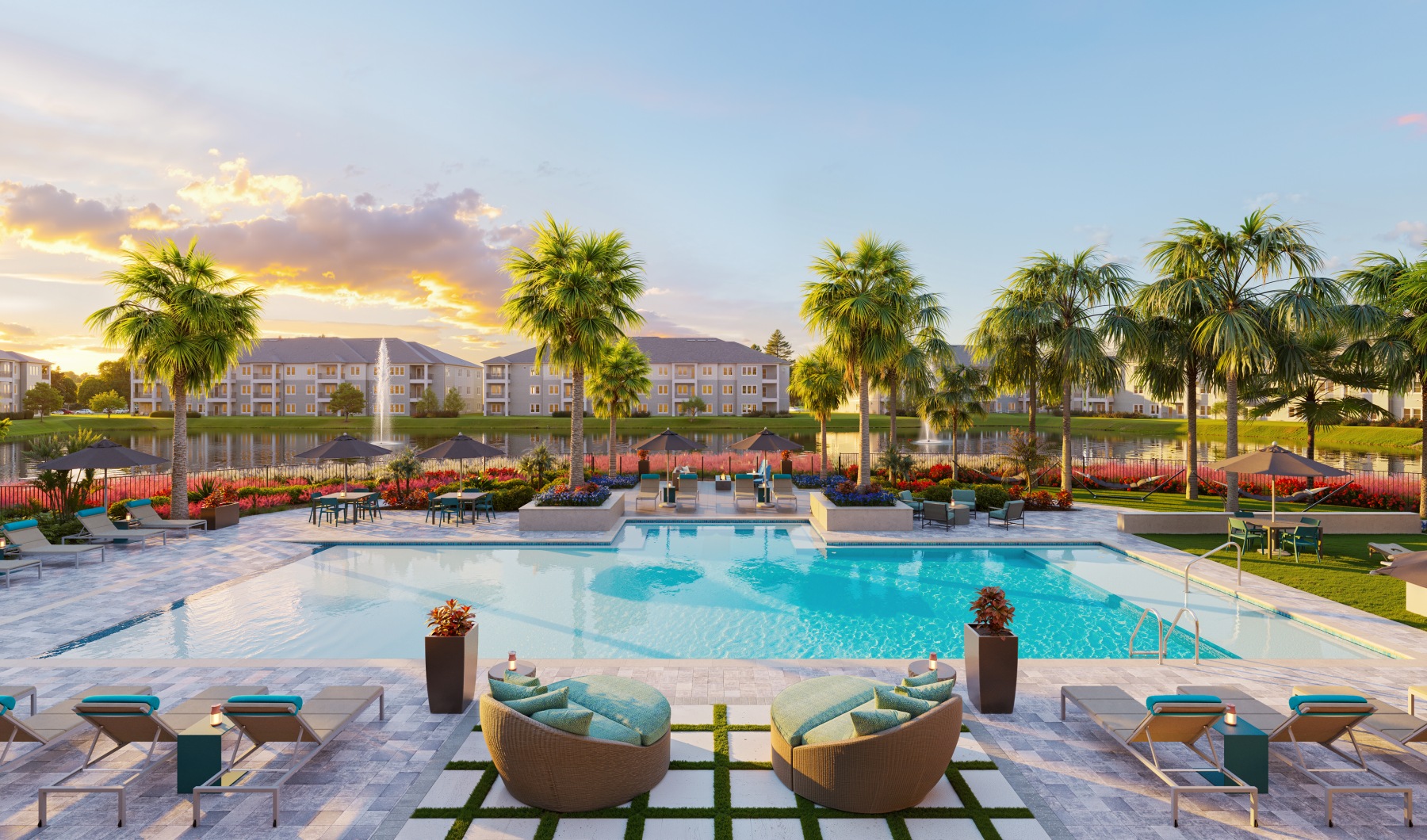 sunset pool sundeck chaise lounges palm trees buildings seating