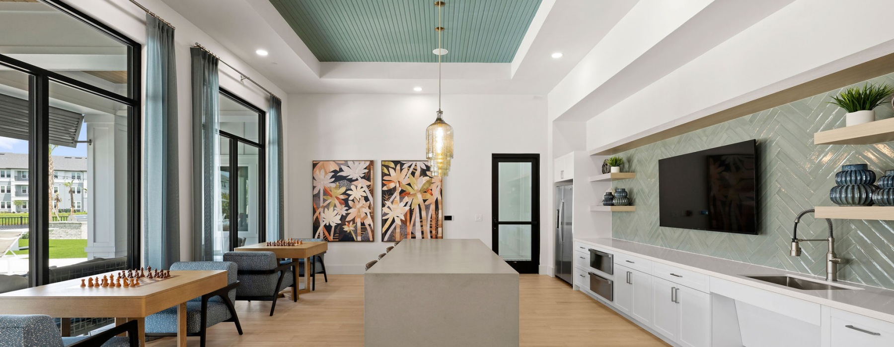 selene tomoka village demo kitchen lounge island barstools pendant lighting chess game tables flat screen TV
