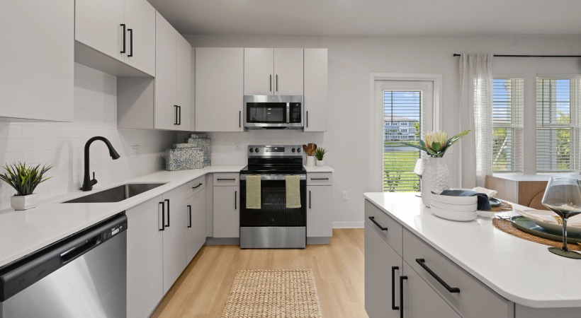 selene tomoka village modern kitchen gray cabinets island barstools stainless steel appliances wood style flooring