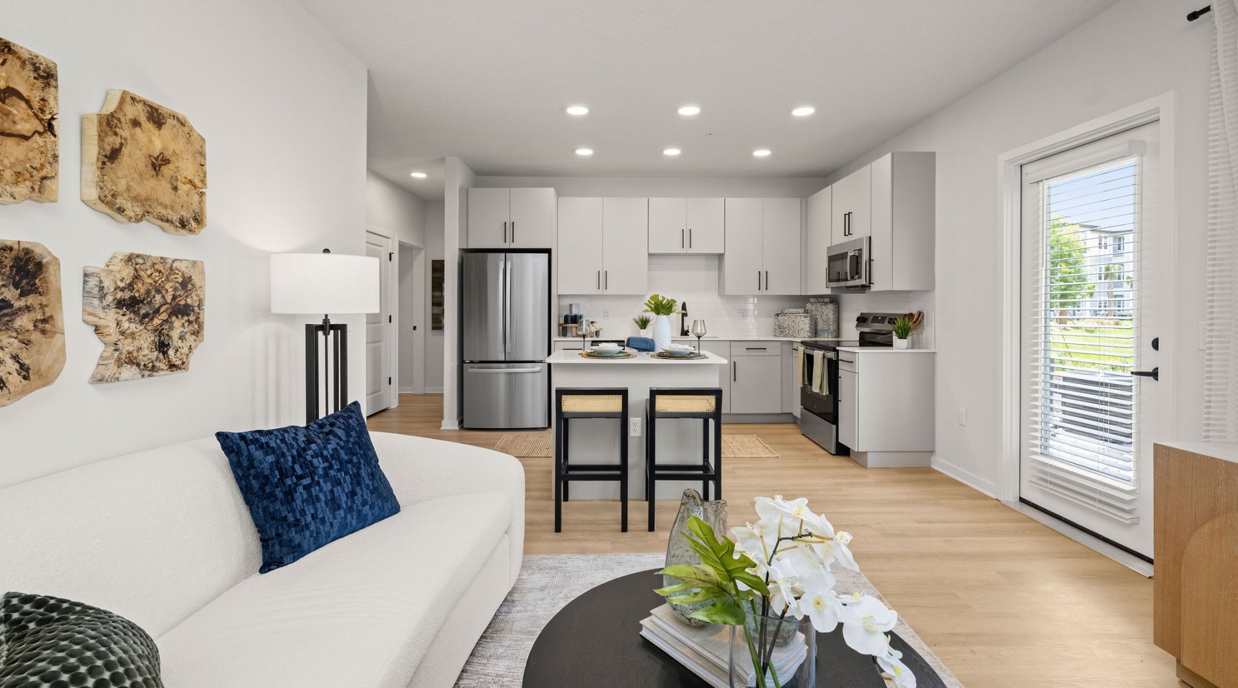 selene tomoka apartment home living kitchen area island barstools sofa table recessed lighting balcony door