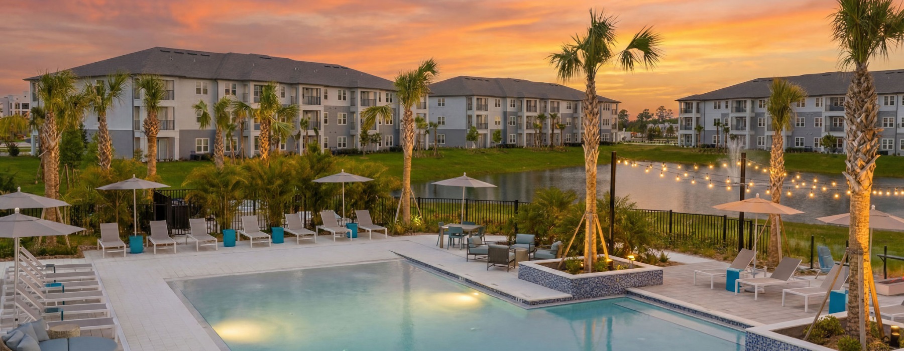 selene tomoka swimming pool sundeck sunset palm trees buildings chaise lounges