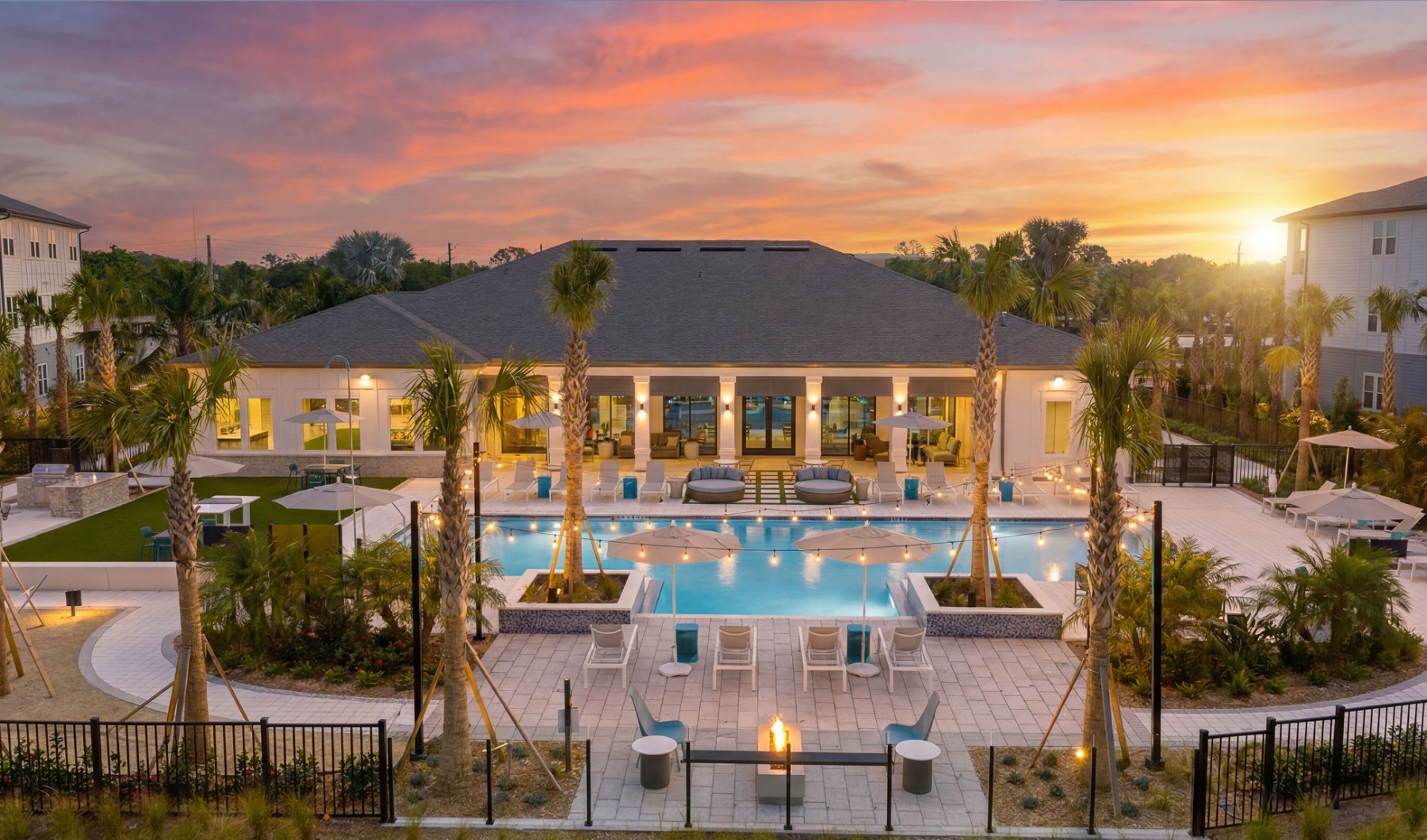 selene tomoka swimming pool sunset hues clubhouse palm trees seating